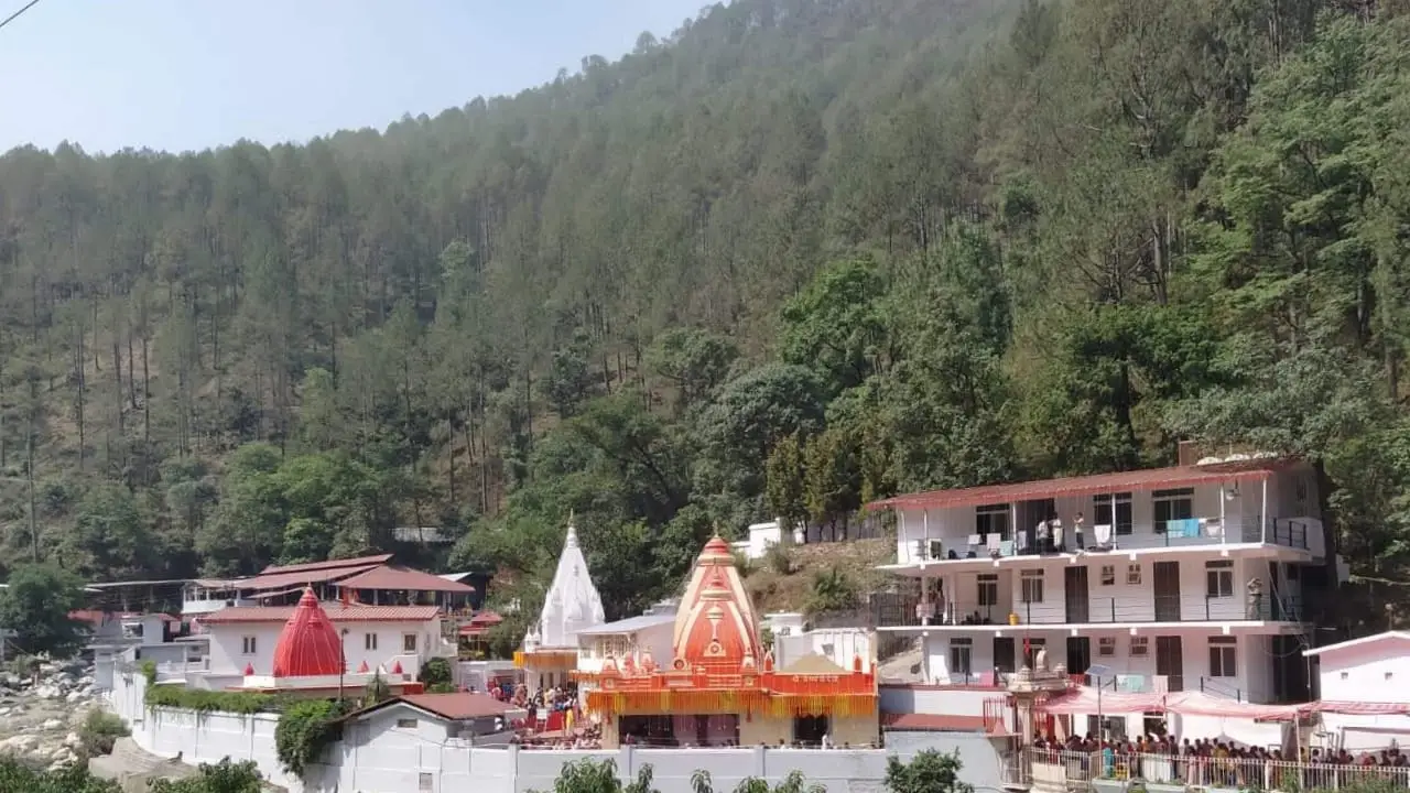 Same day Kainchi Dham tour from Kathgodam railway station - pilgrims visiting the ashram temple between lush green Kumaon hills with Kosi river flowing nearby
